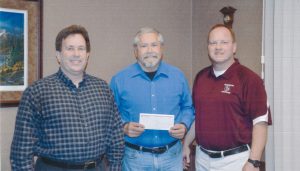 Henderson Community Foundation President Norm Yoder was presented with a check for the Henderson Community Foundation Scholarship Fund from Henderson State Bank, represented by Kevin Postier and JB Suddarth. 